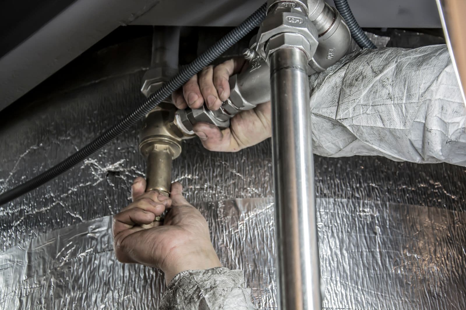 Licensed plumber performing pipe repair work in Van Buren